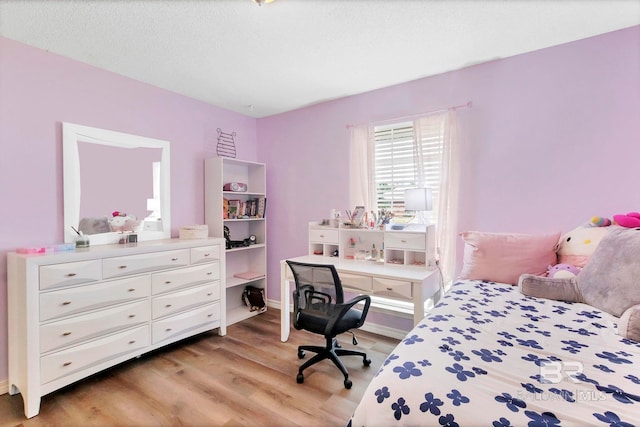 bedroom featuring baseboards and light wood-style flooring