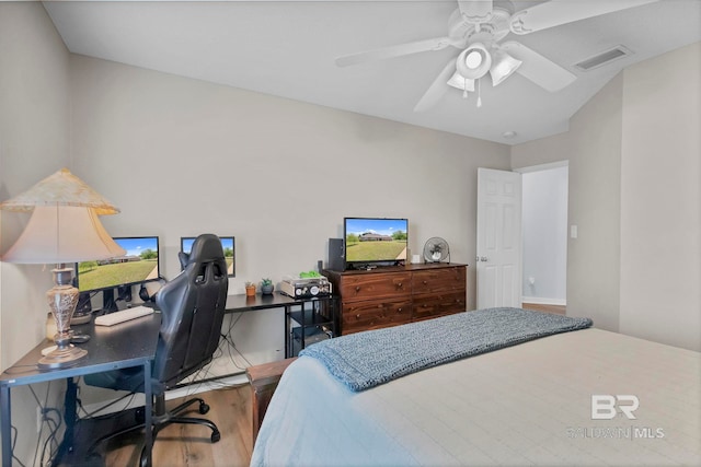 bedroom featuring ceiling fan, wood finished floors, and visible vents