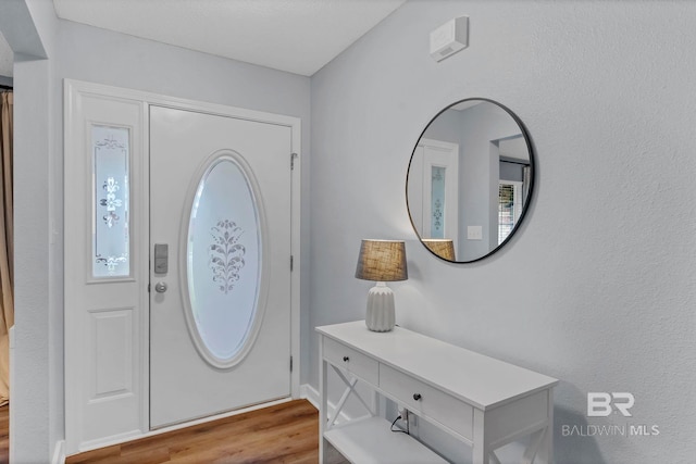 entryway with wood finished floors