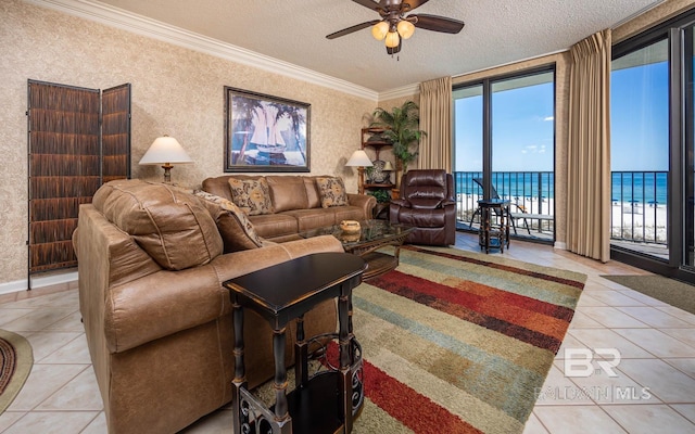 living room with ornamental molding, a water view, light tile patterned floors, and a textured ceiling