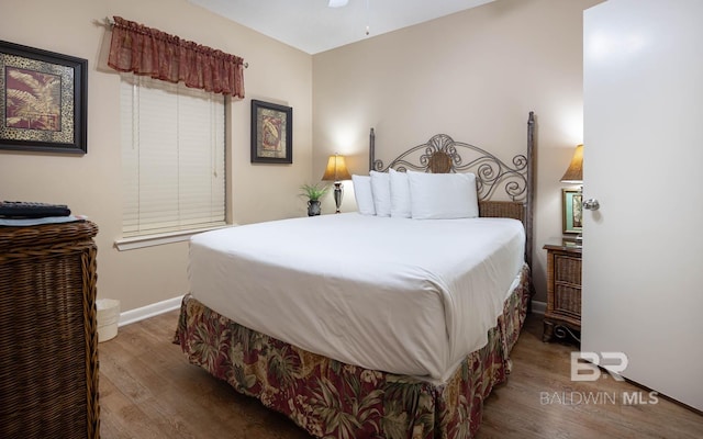 bedroom with dark hardwood / wood-style floors