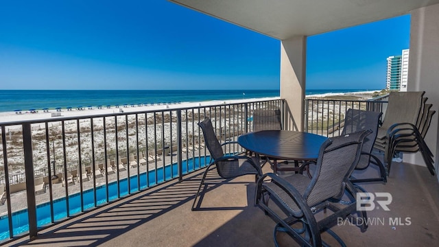 balcony featuring a beach view and a water view