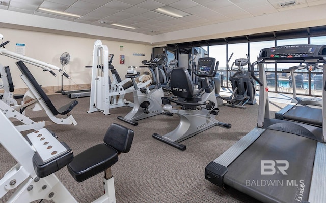 exercise room featuring a drop ceiling