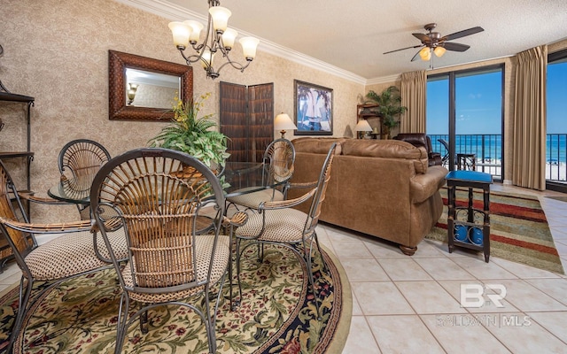 dining room featuring light tile patterned flooring, a water view, crown molding, a textured ceiling, and ceiling fan with notable chandelier