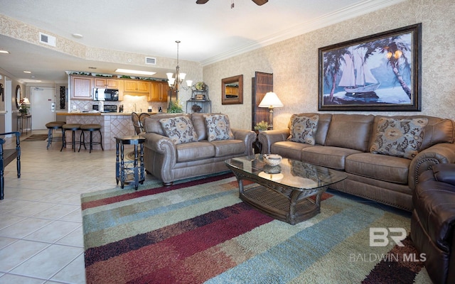 tiled living room with ornamental molding and ceiling fan with notable chandelier