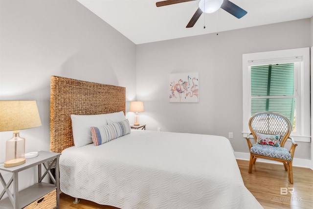 bedroom featuring baseboards, a ceiling fan, and wood finished floors