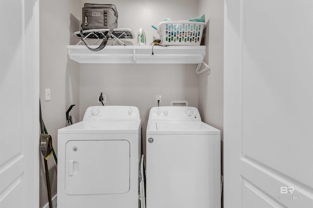clothes washing area with washer and dryer and laundry area
