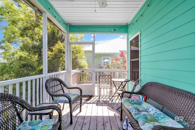 sunroom featuring ceiling fan and outdoor lounge area