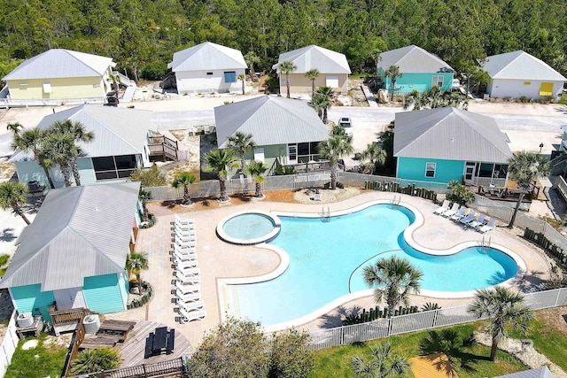 community pool with fence and a residential view
