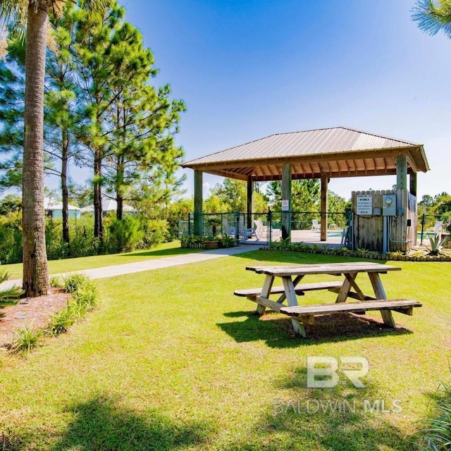 view of property's community featuring a gazebo, fence, and a yard