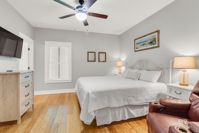 bedroom featuring light wood-type flooring, a ceiling fan, and baseboards