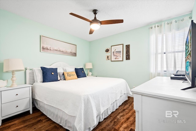 bedroom with a textured ceiling, dark hardwood / wood-style floors, and ceiling fan