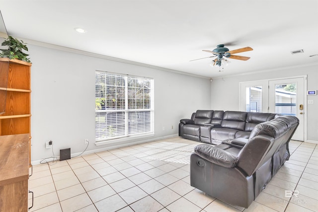 living room featuring ceiling fan, light tile patterned floors, and ornamental molding