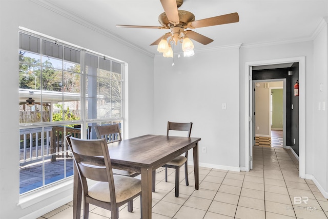 dining area with a wealth of natural light, ceiling fan, light tile patterned floors, and ornamental molding