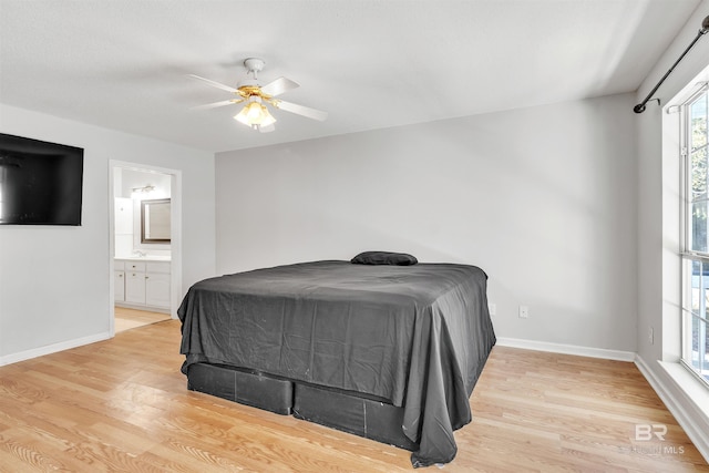 bedroom with light hardwood / wood-style floors, ceiling fan, and ensuite bathroom