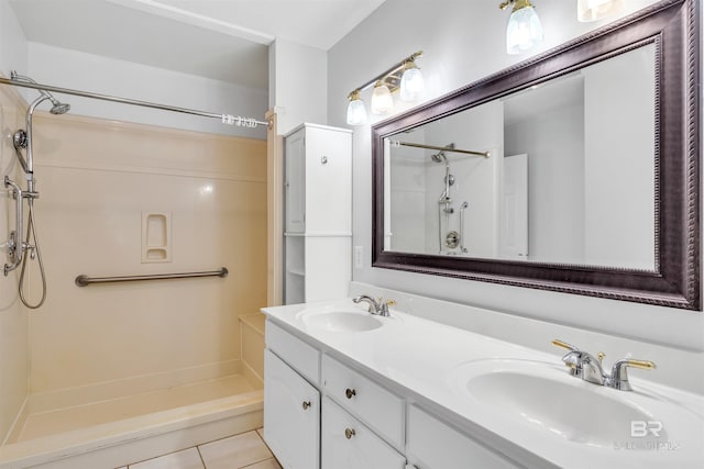 bathroom featuring tile patterned flooring, a shower, and vanity