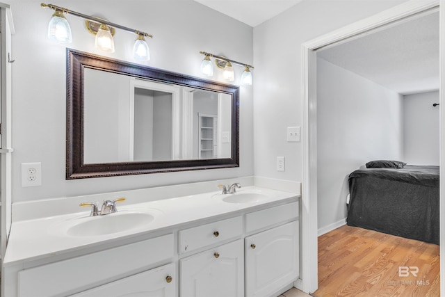 bathroom with hardwood / wood-style floors and vanity