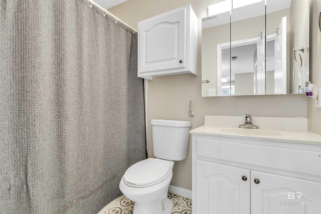 bathroom with tile patterned floors, vanity, and toilet