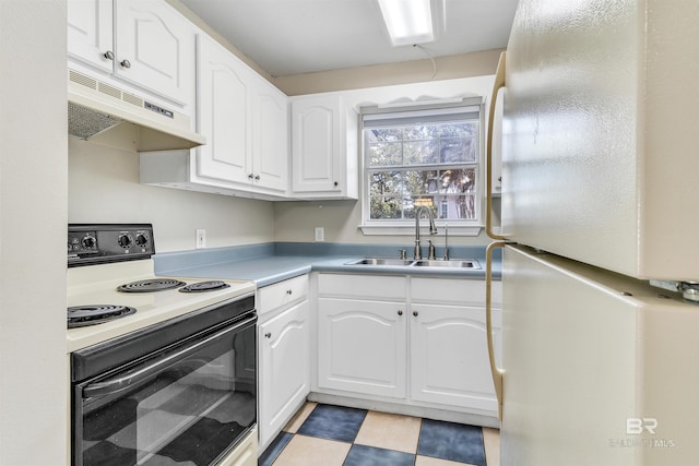 kitchen featuring electric range, white fridge, white cabinetry, and sink