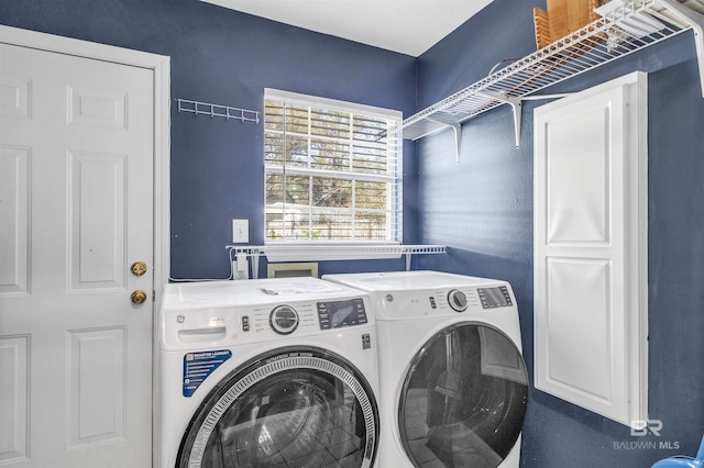 clothes washing area featuring washer and dryer