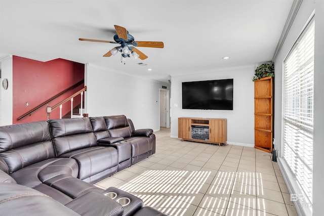 tiled living room with ceiling fan and crown molding