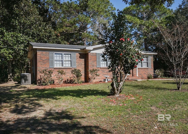 view of front of house featuring a front yard and central air condition unit