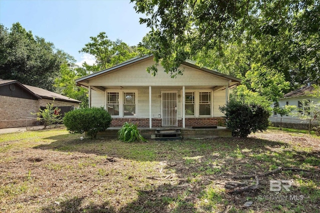 672 Burden St, Mobile, AL 36607 - bungalow featuring covered porch, fence, and brick siding