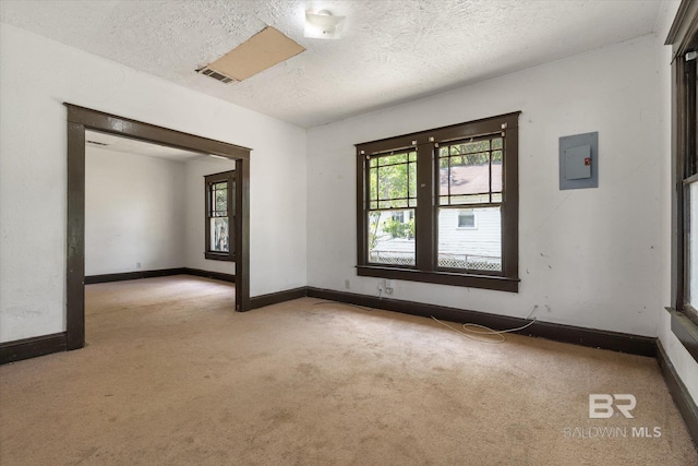 672 Burden St, Mobile, AL 36607 - unfurnished room with light carpet, healthy amount of natural light, a textured ceiling, and baseboards