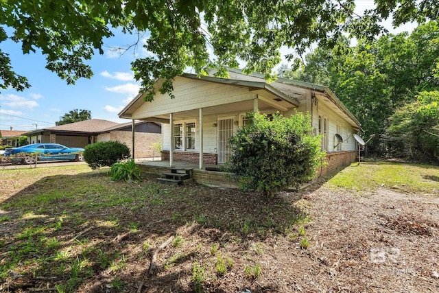 672 Burden St, Mobile, AL 36607 - bungalow-style home with covered porch and brick siding
