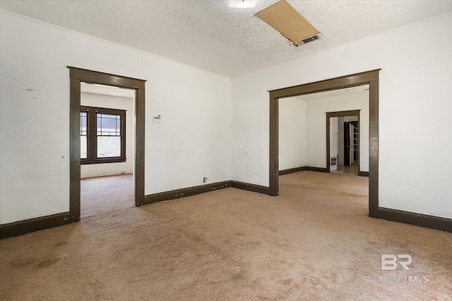 672 Burden St, Mobile, AL 36607 - carpeted spare room with baseboards and a textured ceiling