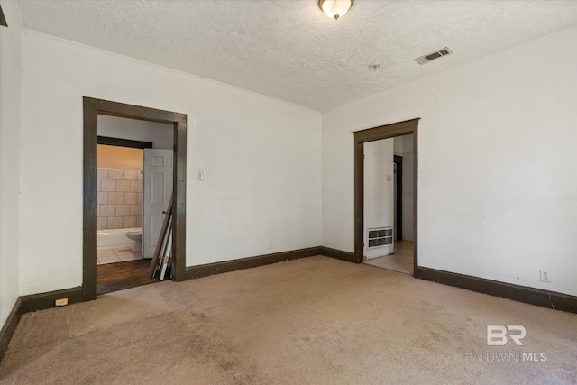 672 Burden St, Mobile, AL 36607 - unfurnished room featuring carpet, a textured ceiling, and baseboards