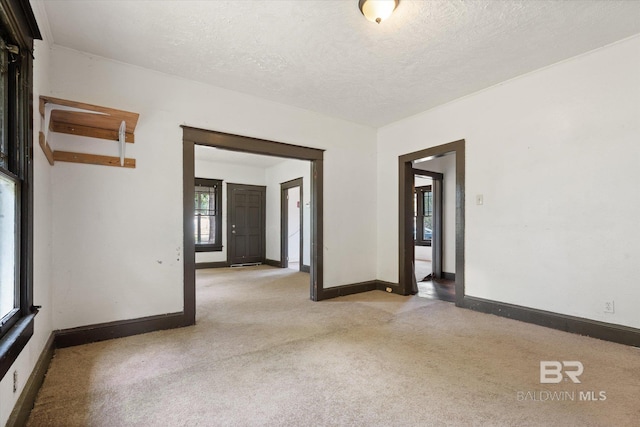 672 Burden St, Mobile, AL 36607 - empty room with light colored carpet, baseboards, and a textured ceiling