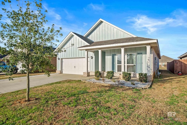 view of front of property featuring a garage and a front lawn