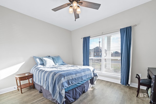 bedroom with hardwood / wood-style floors and ceiling fan