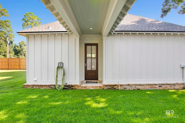 doorway to property featuring a yard