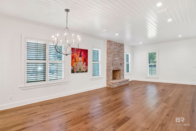 unfurnished living room featuring plenty of natural light, hardwood / wood-style floors, and ornamental molding