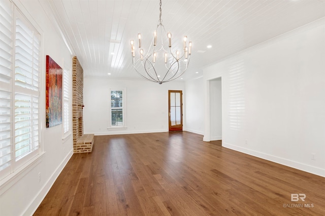 interior space featuring dark hardwood / wood-style floors, a notable chandelier, and ornamental molding