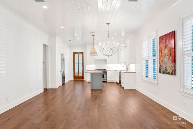 kitchen featuring dark hardwood / wood-style floors, a center island, and ornamental molding