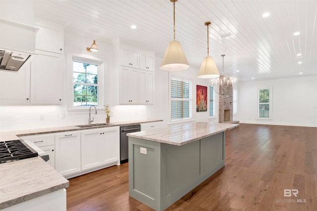 kitchen with decorative backsplash, light wood-type flooring, hanging light fixtures, dishwasher, and sink