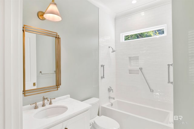 full bathroom with vanity, tiled shower / bath combo, and toilet