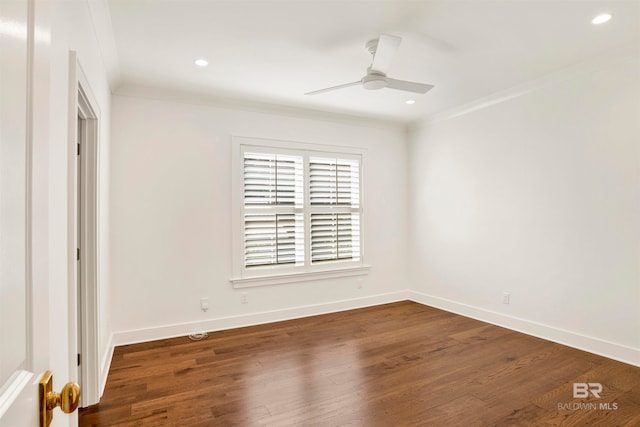 spare room featuring ceiling fan, dark wood-type flooring, and ornamental molding