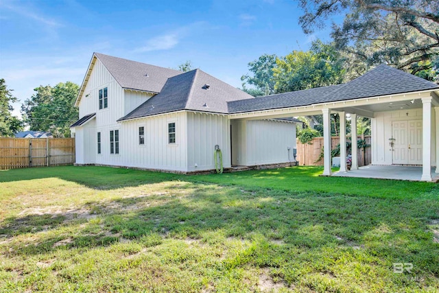 back of property featuring a patio area and a lawn