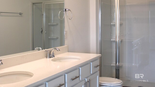 8992 Chabo Cir, Foley, AL 36535 - bathroom featuring toilet, a stall shower, and double vanity