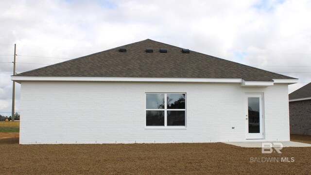 8992 Chabo Cir, Foley, AL 36535 - rear view of house featuring roof with shingles, brick siding, and a yard