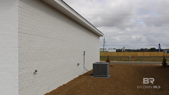 8992 Chabo Cir, Foley, AL 36535 - view of property exterior featuring central AC and fence