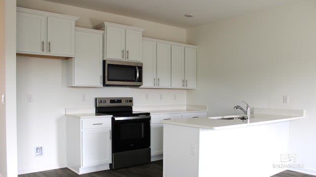 8992 Chabo Cir, Foley, AL 36535 - kitchen featuring stainless steel appliances, dark wood-style flooring, light countertops, and white cabinetry