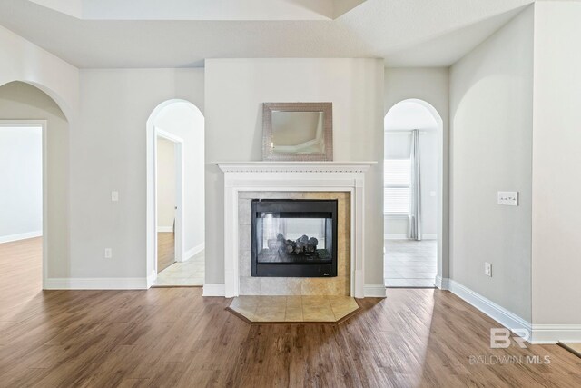 unfurnished living room featuring light tile patterned floors and ceiling fan