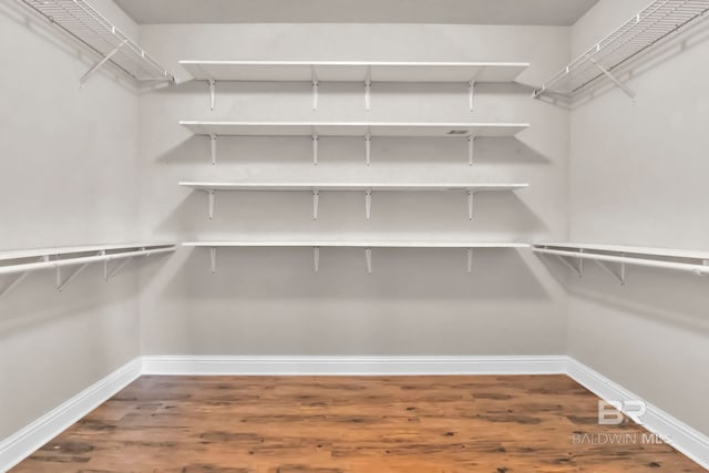 spacious closet featuring hardwood / wood-style floors