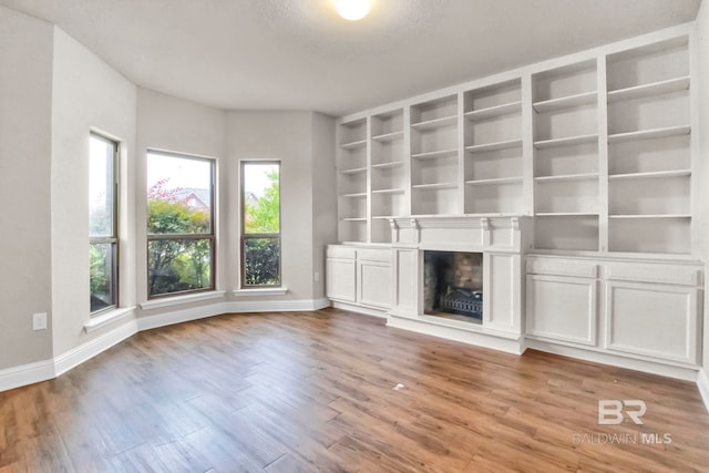 unfurnished living room with wood-type flooring