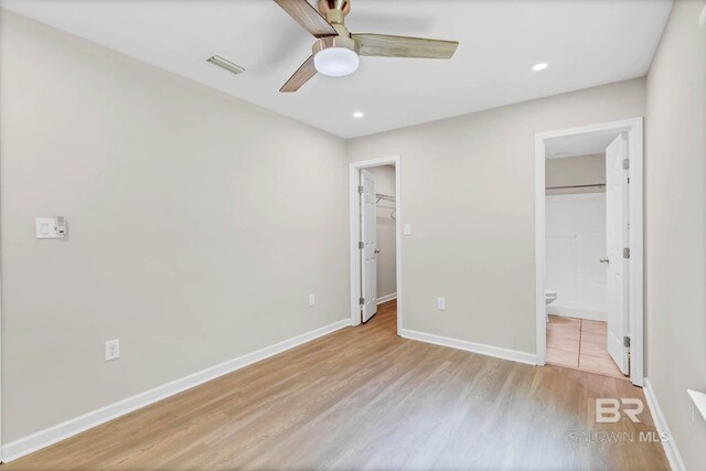 15030 Marem Dr, Foley, AL 36535 - unfurnished bedroom featuring wood finished floors, a walk in closet, recessed lighting, ceiling fan, and ensuite bathroom